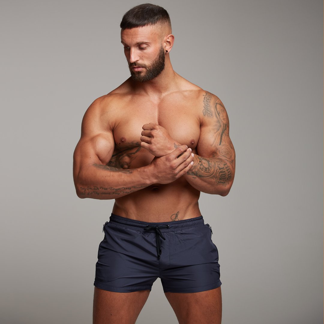 A man wearing gray color European and American quick-drying fitness shorts a product from mensathletix the best Men athletic shorts Gym shorts Mens running shorts Crossfit shorts Sports shorts sports shorts for men gym shorts