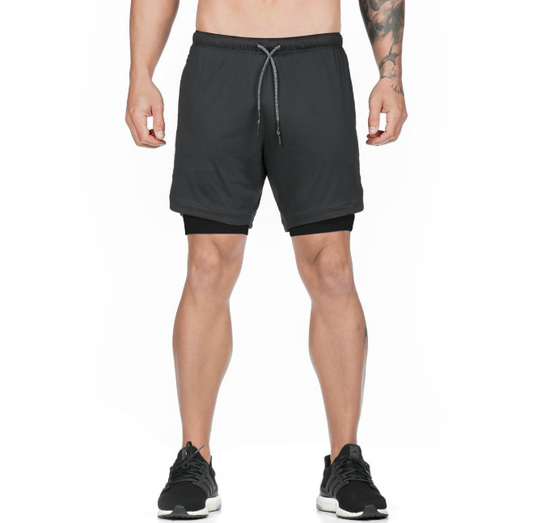 A man wearing black color ATHX DualSport Fitness Shorts a product from mensathletix the best Men athletic shorts Gym shorts Mens running shorts Crossfit shorts Sports shorts sports shorts for Men gym shorts