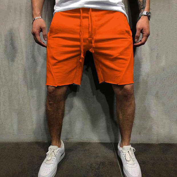 A man wearing orange color ActiveFlex Summer Gym Shorts a product from mensathletix the best Men athletic shorts Gym shorts Mens running shorts Crossfit shorts Sports shorts sports shorts for men Men gym shorts