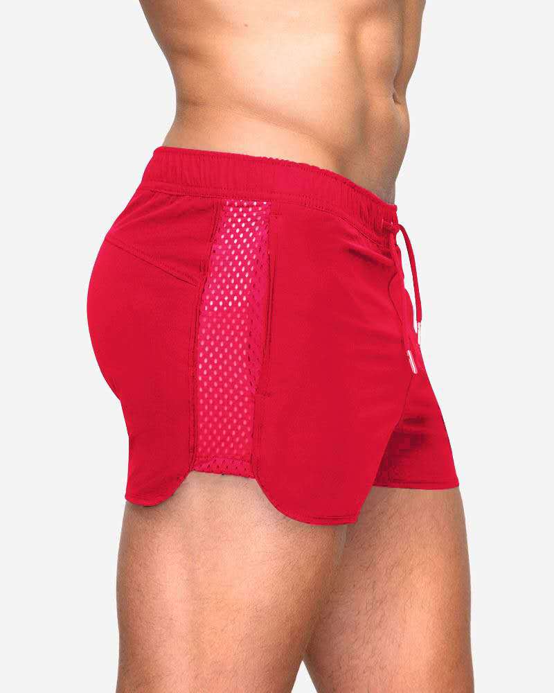 A man wearing red color ATHX EuroSport Surf Shorts a product from mensathletix the best Men athletic shorts Gym shorts Mens running shorts Crossfit shorts Sports shorts sports shorts for Men gym shorts