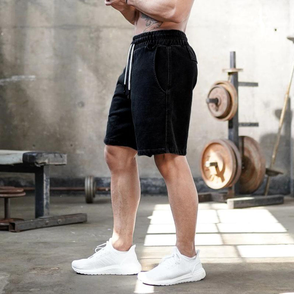 A man wearing  black color ATHX FlexFit Summer Shorts a product from mensathletix the best Men athletic shorts Gym shorts Mens running shorts Crossfit shorts Sports shorts sports shorts for Men gym shorts