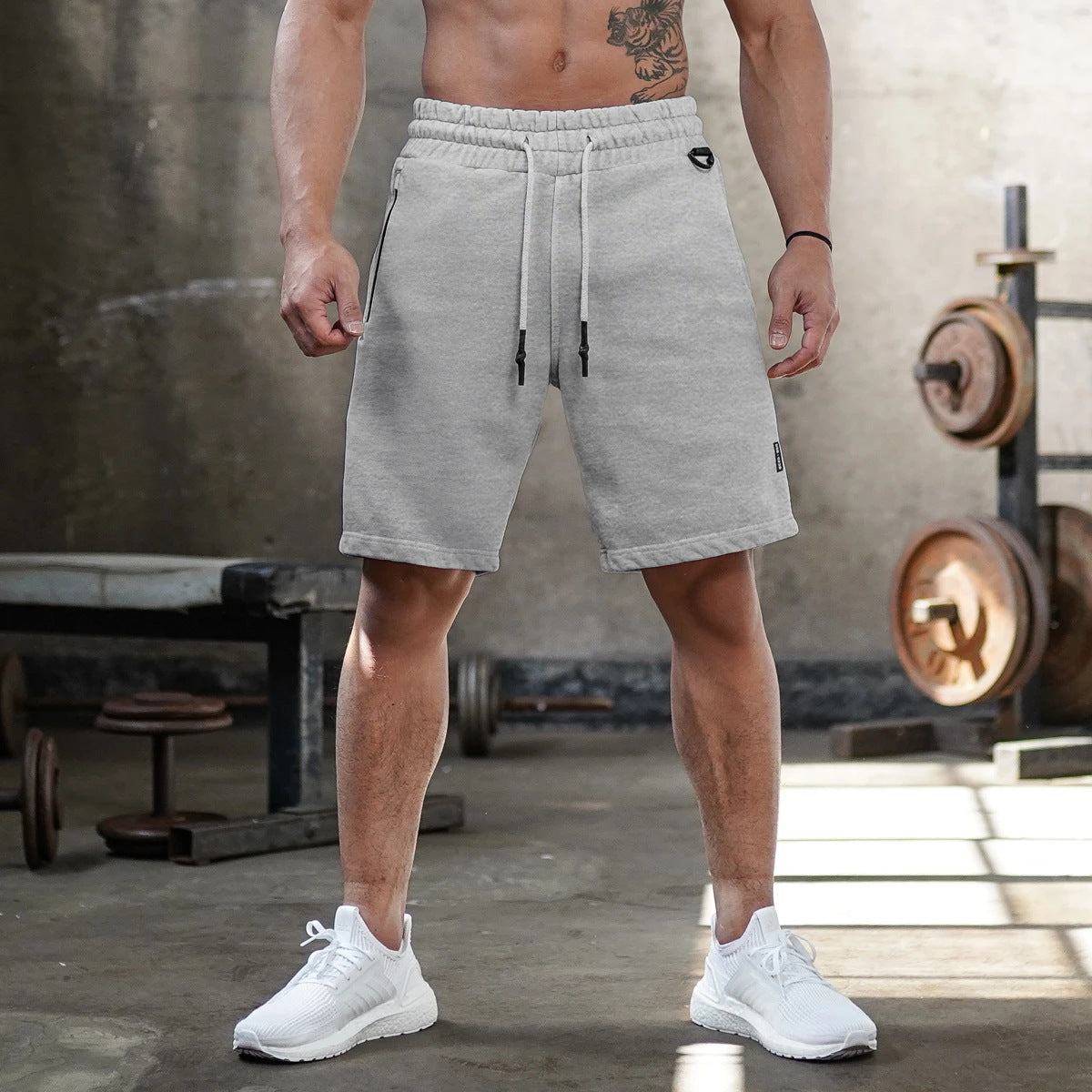 A man wearing ash color ATHX FlexFit Summer Shorts a product from mensathletix the best Men athletic shorts Gym shorts Mens running shorts Crossfit shorts Sports shorts sports shorts for Men gym shorts