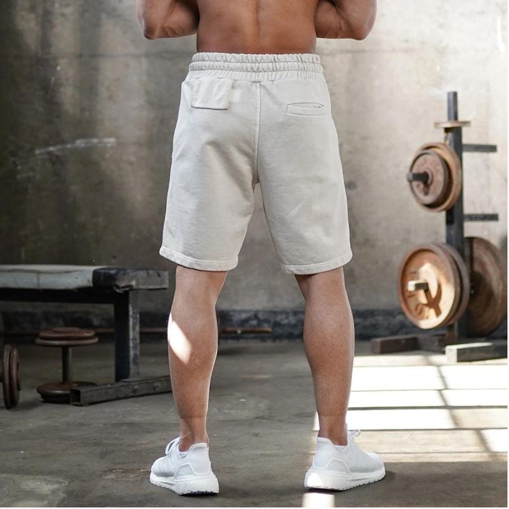 A man wearing ash color ATHX FlexFit Summer Shorts a product from mensathletix the best Men athletic shorts Gym shorts Mens running shorts Crossfit shorts Sports shorts sports shorts for Men gym shorts