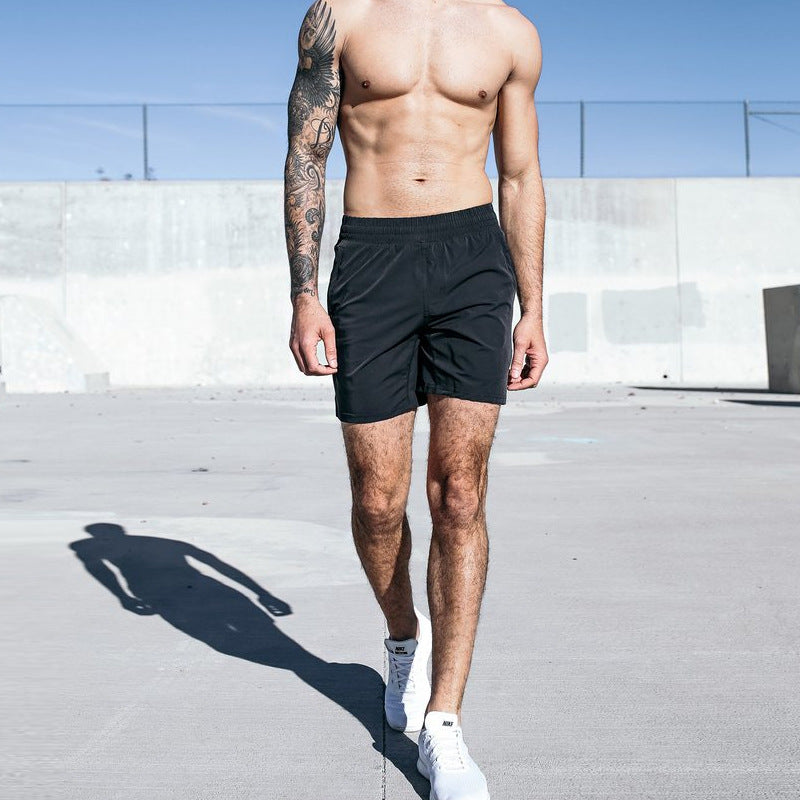 A man wearing black color Fitness Exercise Beach Leisure Pants a product from mensathletix the best Men athletic shorts Gym shorts Mens running shorts Crossfit shorts Sports shorts sports shorts for men gym shorts