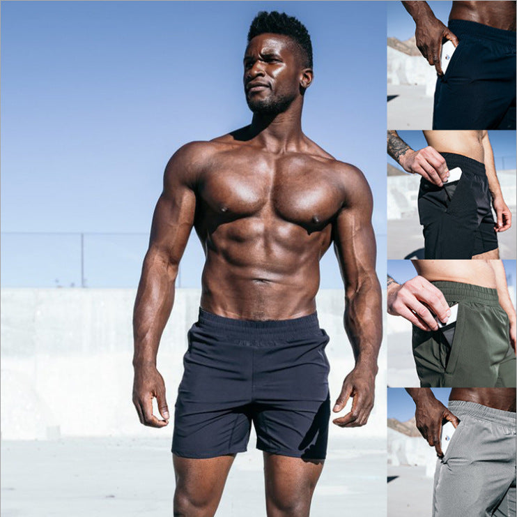 A man wearing gray, black,  army, and navy blue color Fitness Exercise Beach Leisure Pants a product from mensathletix the best Men athletic shorts Gym shorts Mens running shorts Crossfit shorts Sports shorts sports shorts for men gym shorts