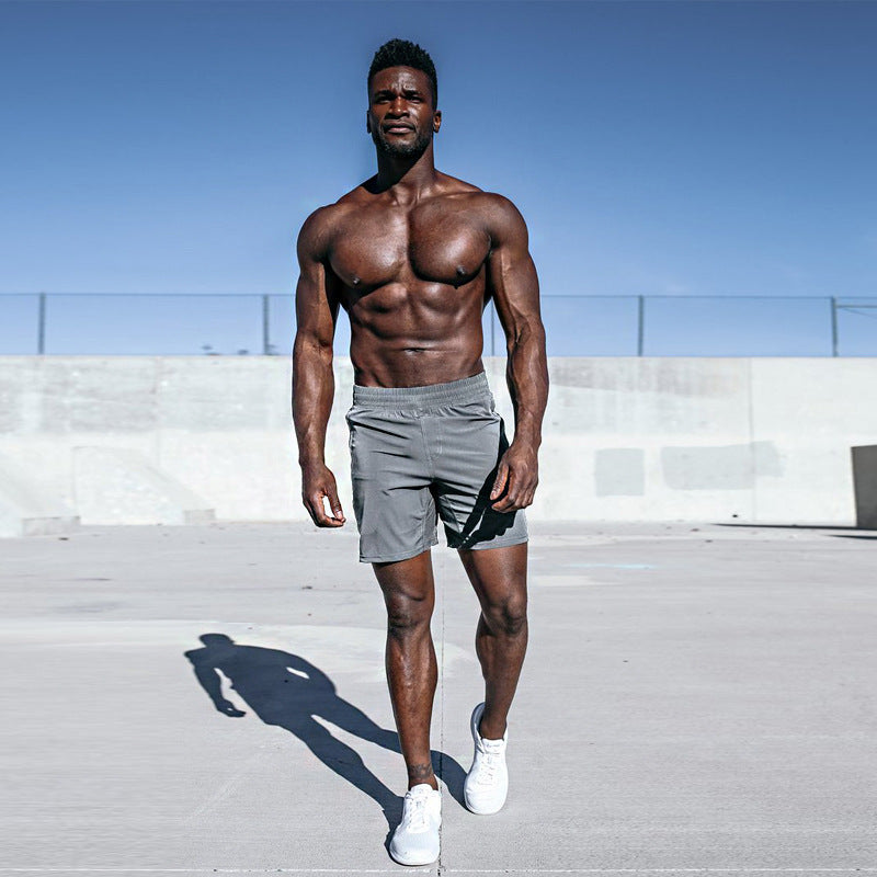 A man wearing gray color Fitness Exercise Beach Leisure Pants a product from mensathletix the best Men athletic shorts Gym shorts Mens running shorts Crossfit shorts Sports shorts sports shorts for men  gym shorts