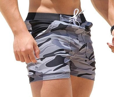 A man wearing camou color ATHX BeachCam Swim Shorts a product from mensathletix the best Men athletic shorts Gym shorts Mens running shorts Crossfit shorts Sports shorts Vouri shorts Men gym shorts