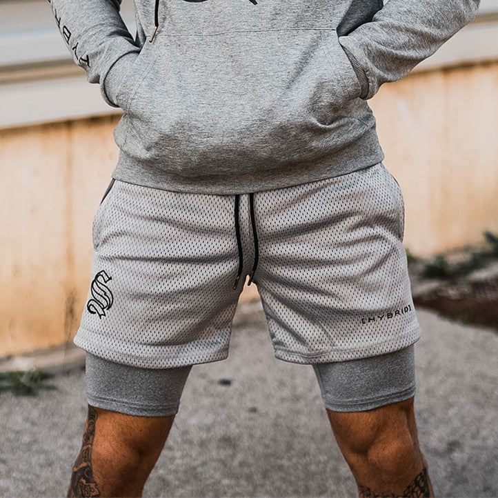 A man wearing ash color ATHX DoubleFlex Sport Shorts a product from mensathletix the best Men athletic shorts Gym shorts Mens running shorts Crossfit shorts Sports shorts sports shorts for Men gym shorts