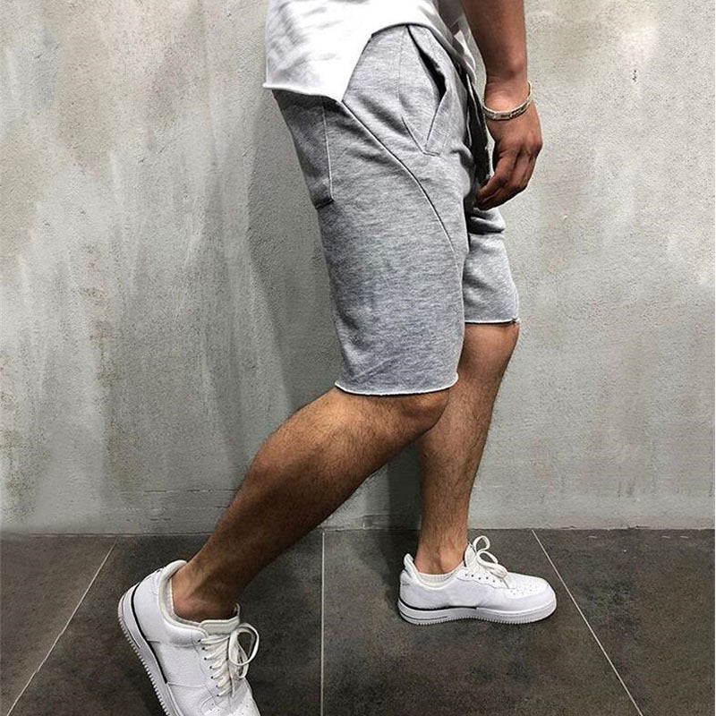 A man wearing ash color ActiveFlex Summer Gym Shorts a product from mensathletix the best Men athletic shorts Gym shorts Mens running shorts Crossfit shorts Sports shorts sports shorts for men Men gym shorts