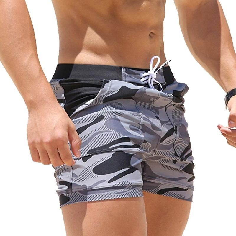 A man wearing camou color ATHX BeachCam Swim Shorts a product from mensathletix the best Men athletic shorts Gym shorts Mens running shorts Crossfit shorts Sports shorts sports shorts for men gym shorts