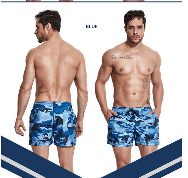 A man wearing blue camou color ATHX TideCam Quick-Dry Beach Shorts a product from mensathletix the best Men athletic shorts Gym shorts Mens running shorts Crossfit shorts Sports shorts sports shorts for men gym shorts