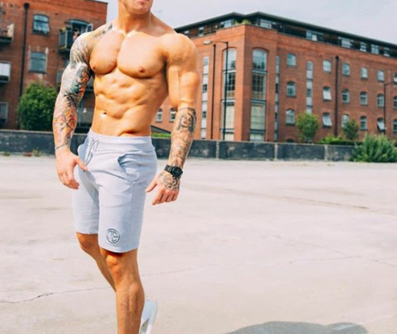 A man wearing ash color Casual men's shorts outdoor fitness pants a product from mensathletix the best Men athletic shorts Gym shorts Mens running shorts Crossfit shorts Sports shorts sports shorts for men gym shorts