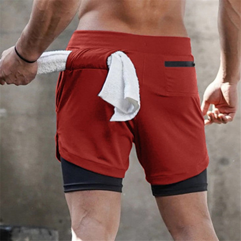 A man wearing red color ATHX DualSport Fitness Shorts a product from mensathletix the best Men athletic shorts Gym shorts Mens running shorts Crossfit shorts Sports shorts sports shorts for Men gym shorts