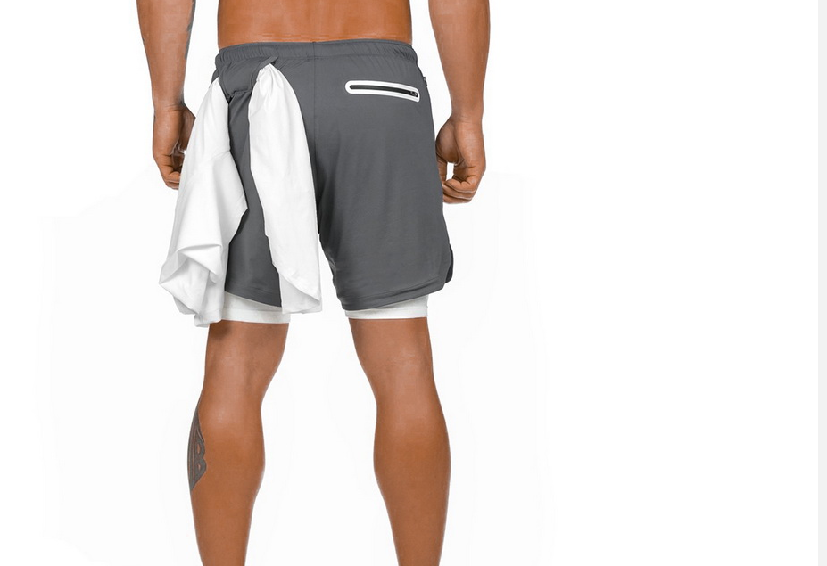 A man wearing ash color ATHX DualSport Fitness Shorts a product from mensathletix the best Men athletic shorts Gym shorts Mens running shorts Crossfit shorts Sports shorts sports shorts for Men gym shorts