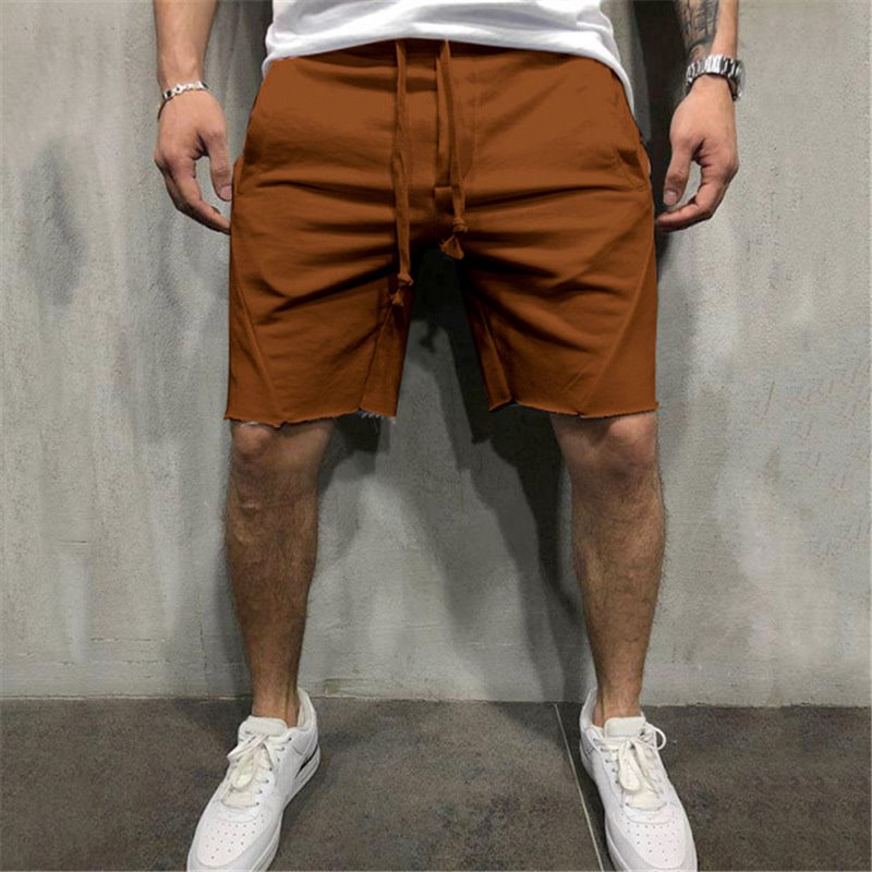 A man wearing brown color ActiveFlex Summer Gym Shorts  a product from mensathletix the best Men athletic shorts Gym shorts Mens running shorts Crossfit shorts Sports shorts sports shorts for men Men gym shorts