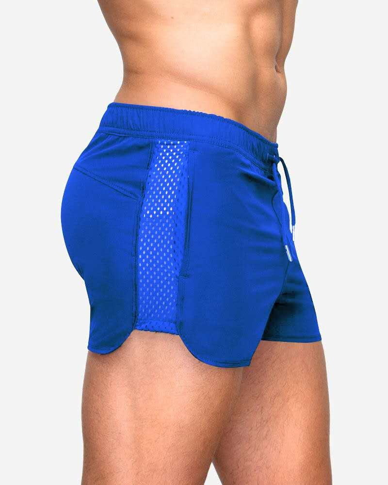 A man wearing blue color ATHX EuroSport Surf Shorts a product from mensathletix the best Men athletic shorts Gym shorts Mens running shorts Crossfit shorts Sports shorts sports shorts for Men gym shorts