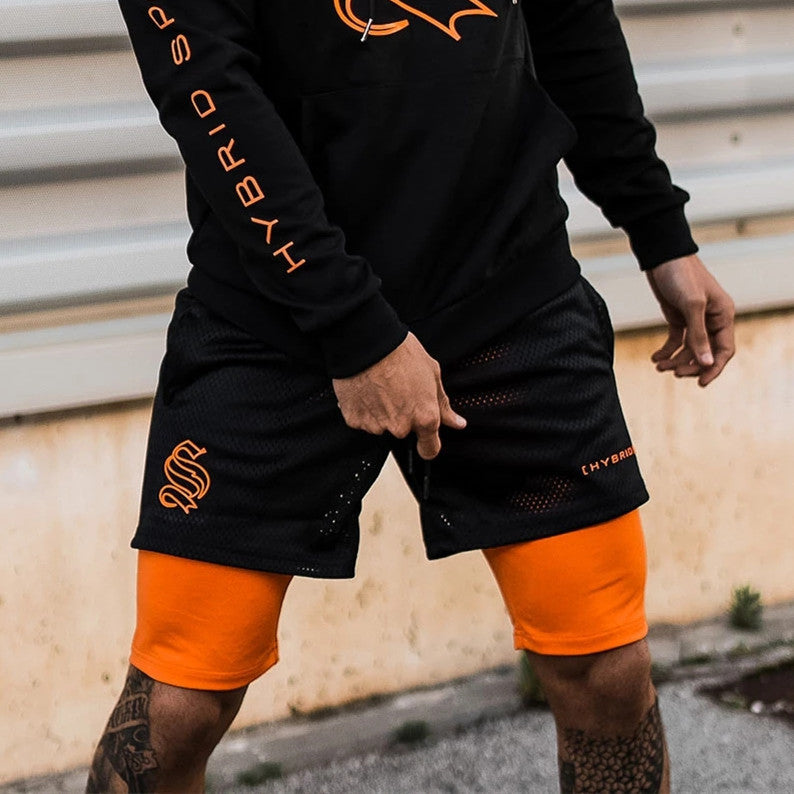 A man wearing black with orange color ATHX DoubleFlex Sport Shorts a product from mensathletix the best Men athletic shorts Gym shorts Mens running shorts Crossfit shorts Sports shorts sports shorts for Men gym shorts