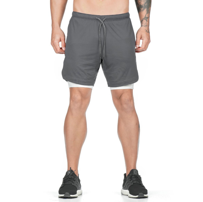 A man wearing ash color ATHX DualSport Fitness Shorts a product from mensathletix the best Men athletic shorts Gym shorts Mens running shorts Crossfit shorts Sports shorts sports shorts for Men gym shorts