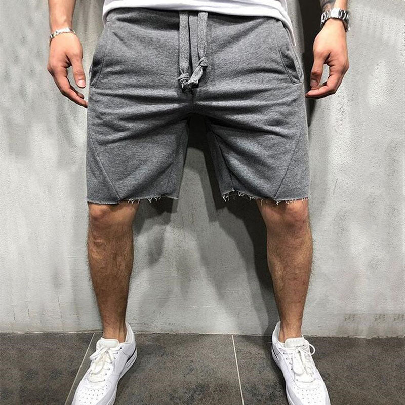 A man wearing ash color ActiveFlex Summer Gym Shorts  a product from mensathletix the best Men athletic shorts Gym shorts Mens running shorts Crossfit shorts Sports shorts sports shorts for men Men gym shorts