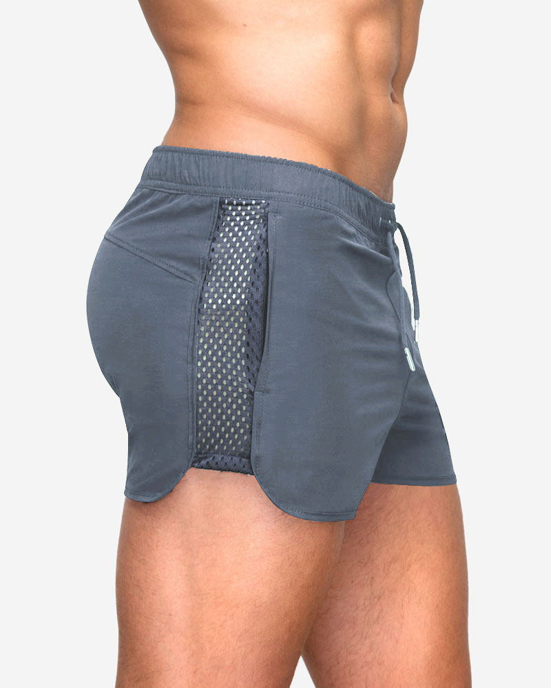 A man wearing ash color ATHX EuroSport Surf Shorts a product from mensathletix the best Men athletic shorts Gym shorts Mens running shorts Crossfit shorts Sports shorts sports shorts for Men gym shorts