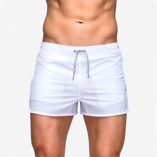 A man wearing white color ATHX EuroSport Surf Shorts a product from mensathletix the best Men athletic shorts Gym shorts Mens running shorts Crossfit shorts Sports shorts sports shorts for Men gym shorts