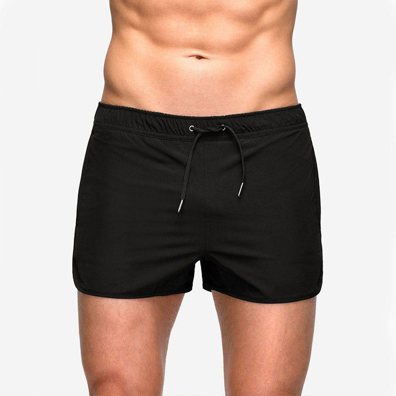 A man wearing black color ATHX EuroSport Surf Shorts a product from mensathletix the best Men athletic shorts Gym shorts Mens running shorts Crossfit shorts Sports shorts sports shorts for Men gym shorts