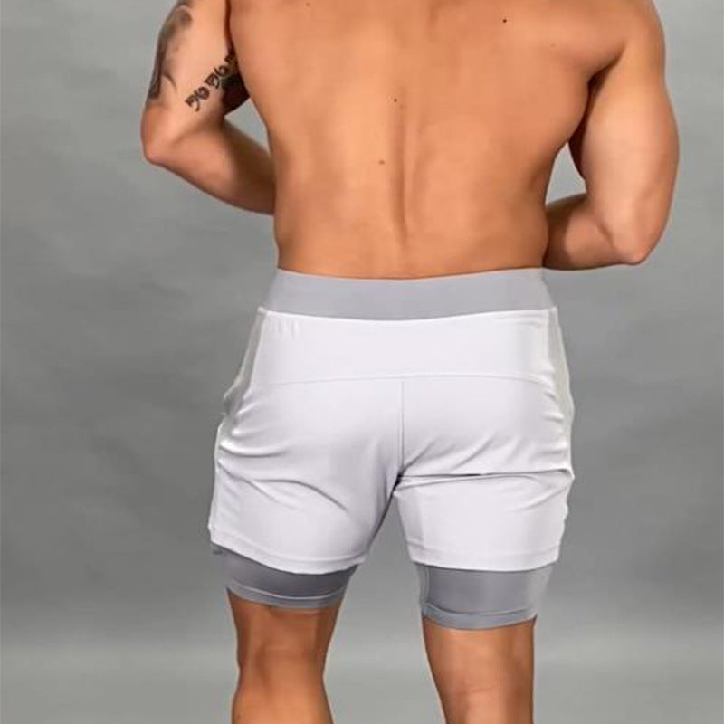 A man wearing white color ATHX 2-in-1 Gym Run Shorts a product from mensathletix the best Men athletic shorts Gym shorts Mens running shorts Crossfit shorts Sports shorts sports shorts for men Men gym shorts